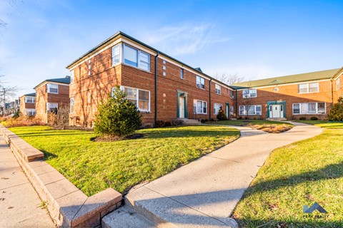 a brick building with a sidewalk in front of it