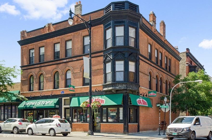a large brick building on the corner of a city street