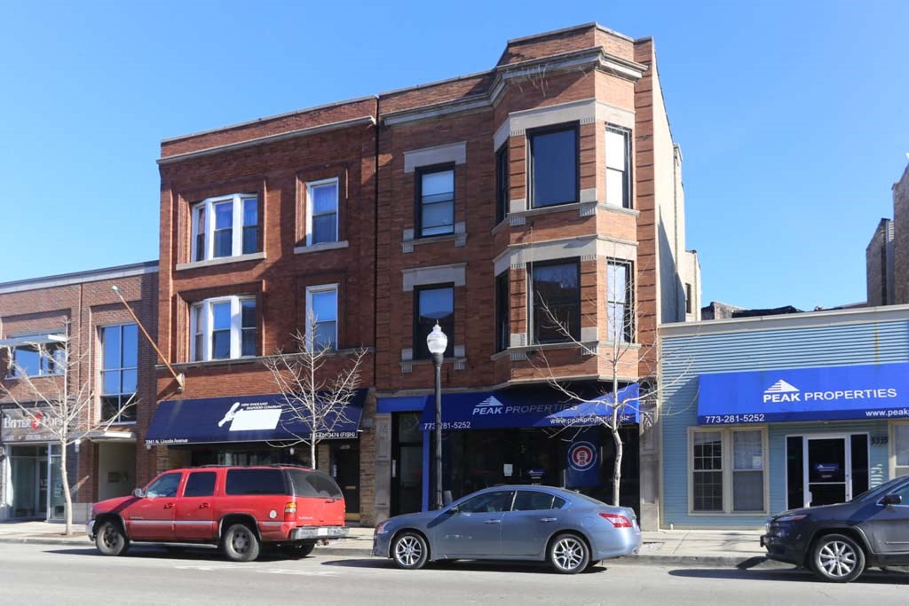 a brick building on the corner of a city street