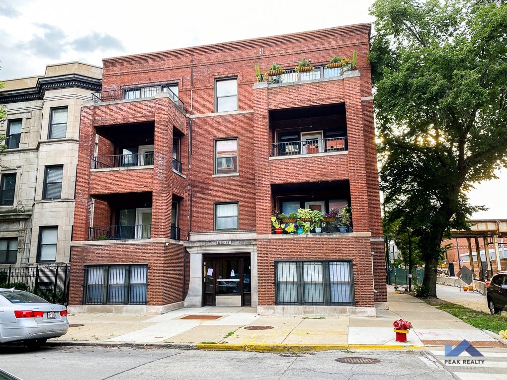 a red brick apartment building on the corner of a street