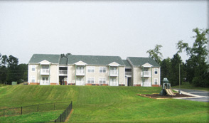 a large apartment building with a tractor in front of it