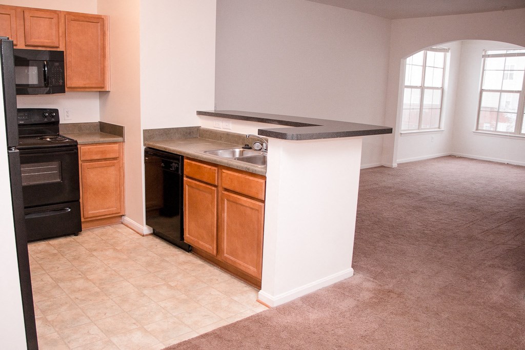 an empty kitchen with a stove and a sink
