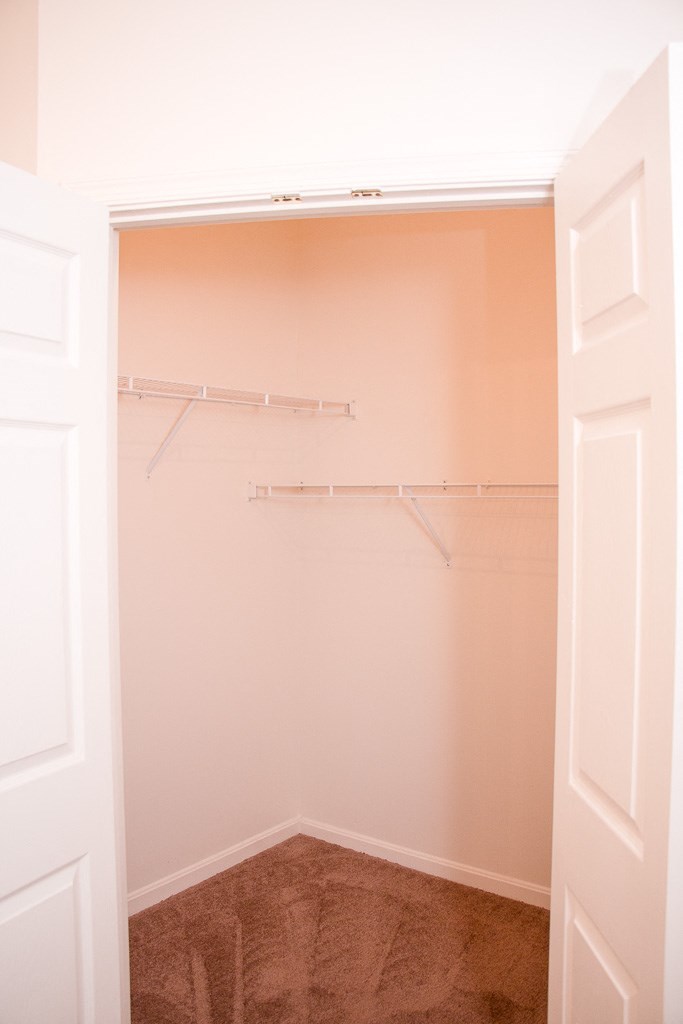 a closet with empty shelves in a white room