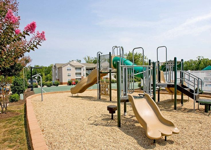 a playground with slides and other toys in a park