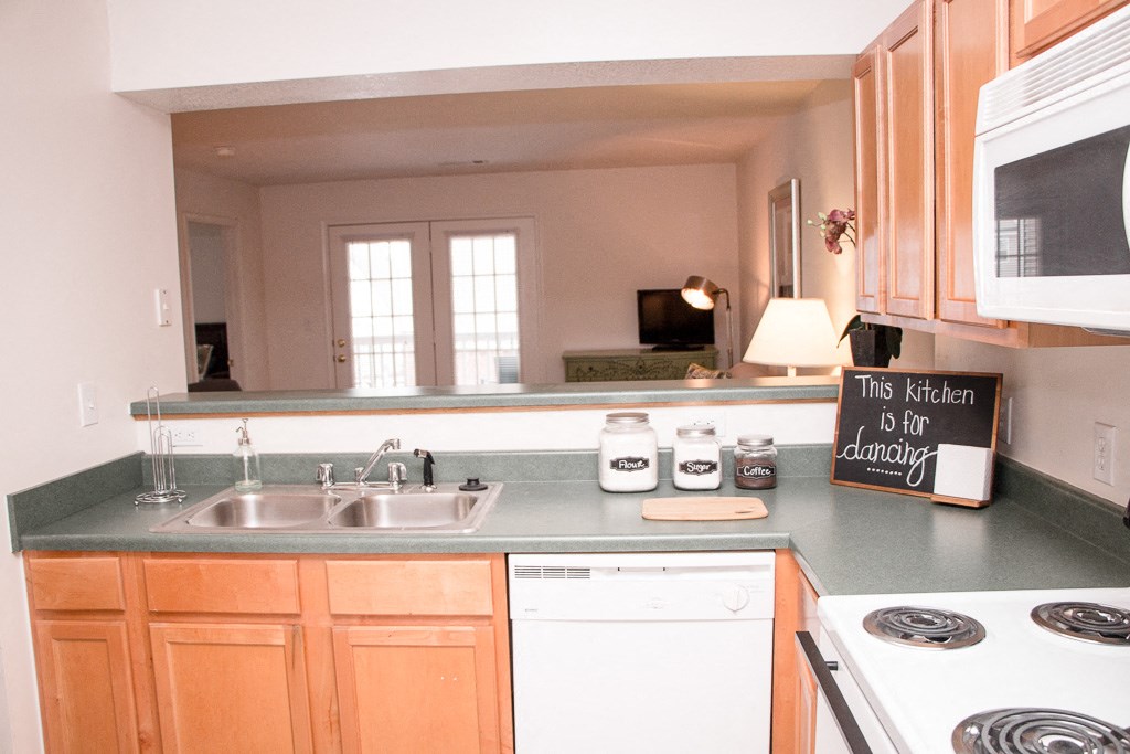 a kitchen with a sink and a counter top and a window