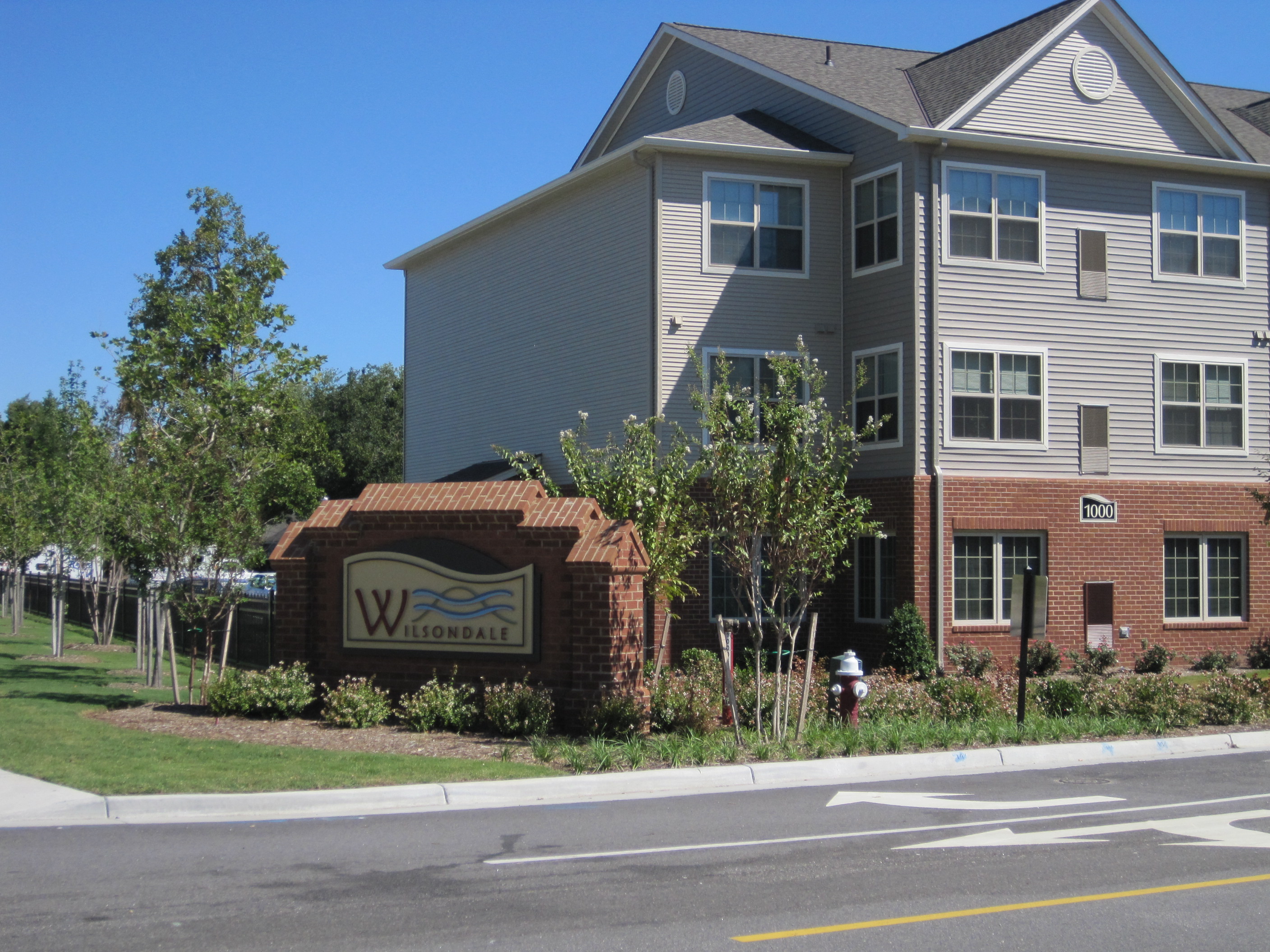 a building with a sign in front of a street