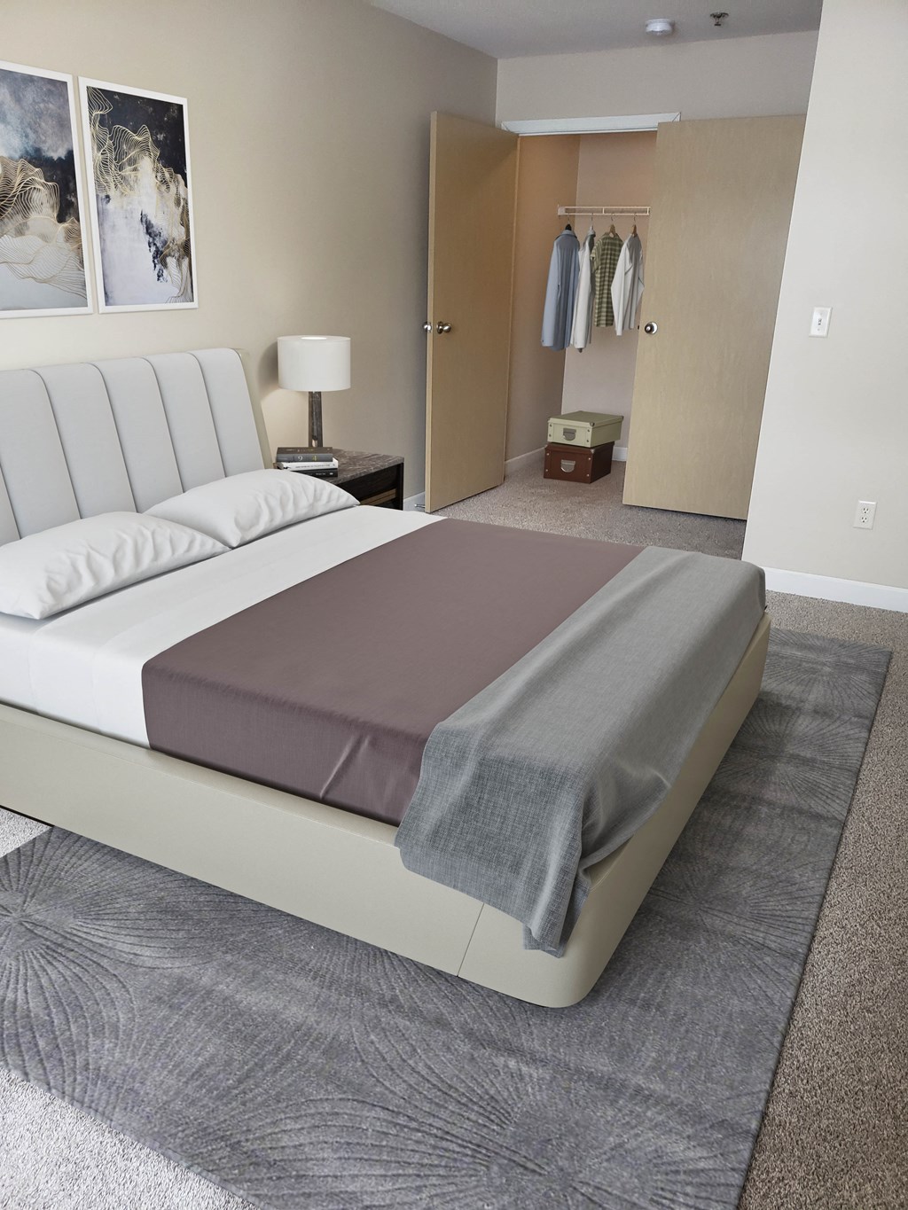 a bed with a gray blanket on it in a room