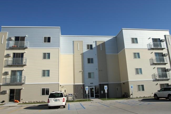 a white car parked in front of an apartment building