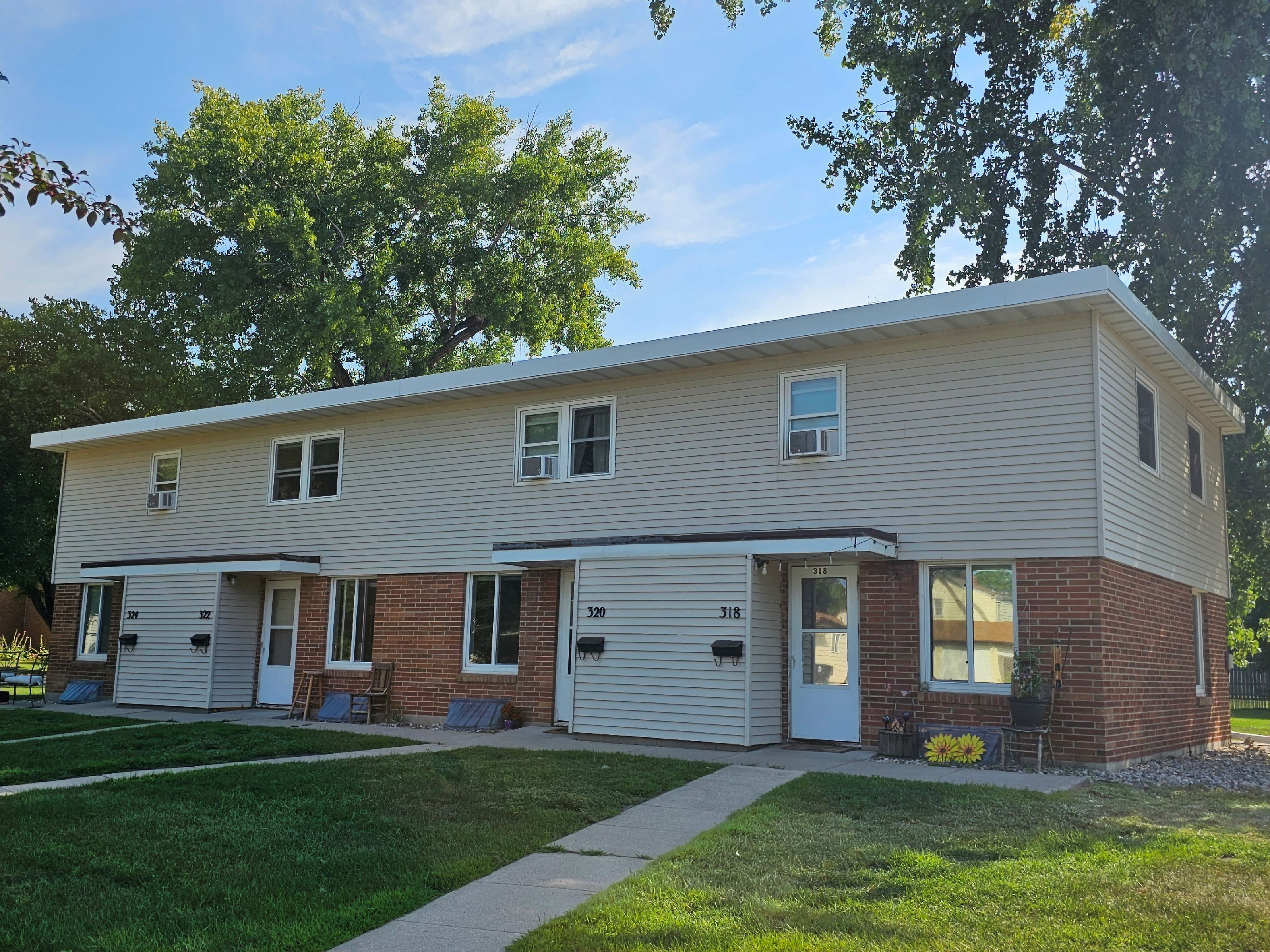 a white house with a sidewalk in front of it
