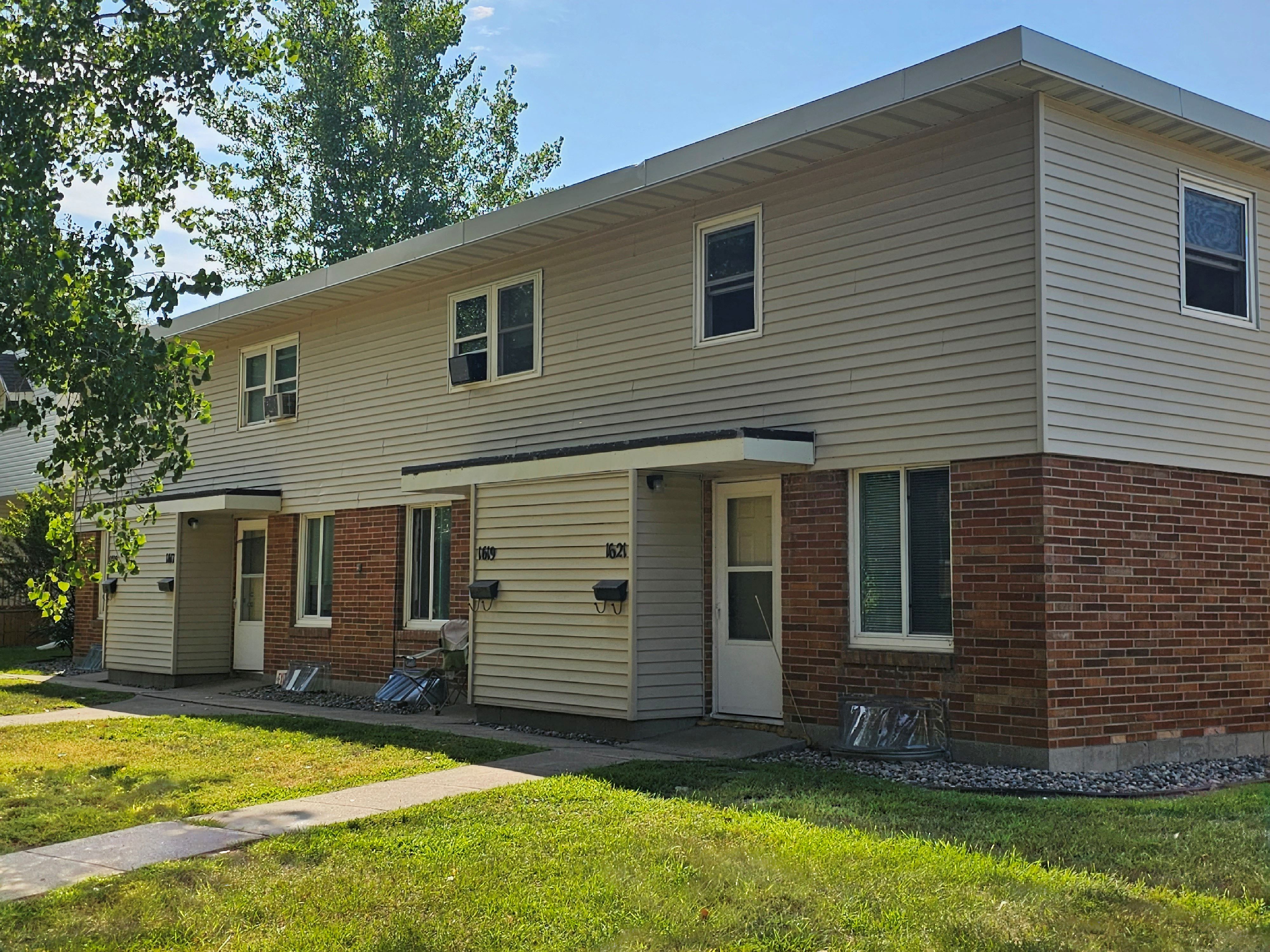 a white house with a sidewalk in front of it