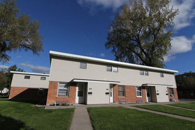 a white house with a sidewalk in front of it