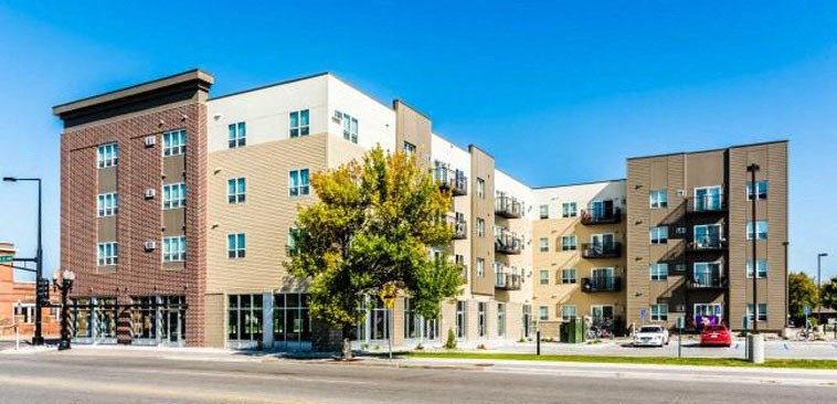 a large apartment building on the corner of a street
