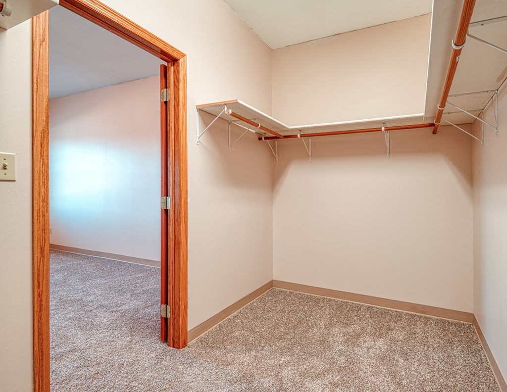 an empty room with a closet and a mirror in it