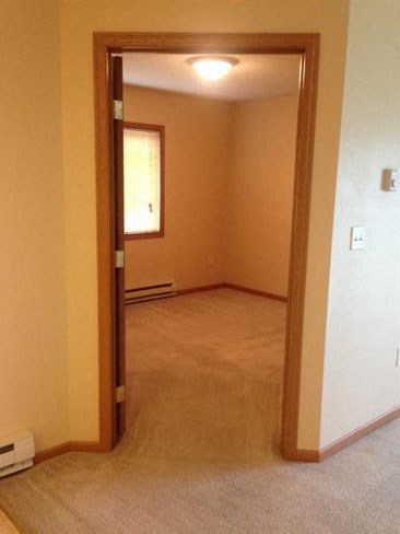 an empty living room with an open door