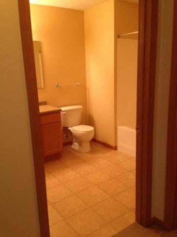a bathroom with a toilet and a sink and a shower