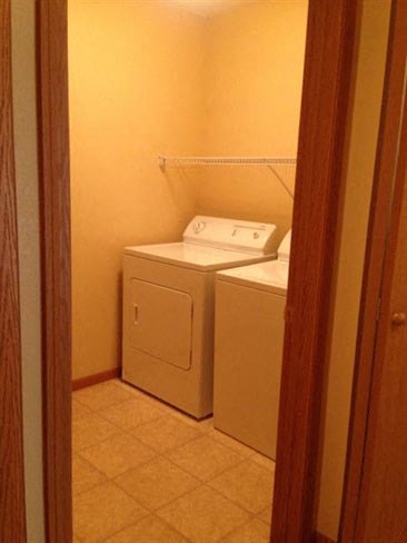 a bathroom with a washer and a dryer in it