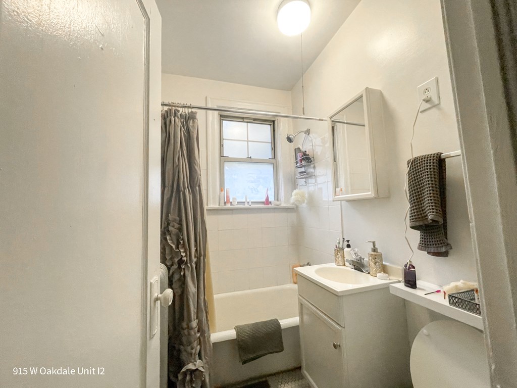 a small bathroom with a shower and a sink and a toilet
