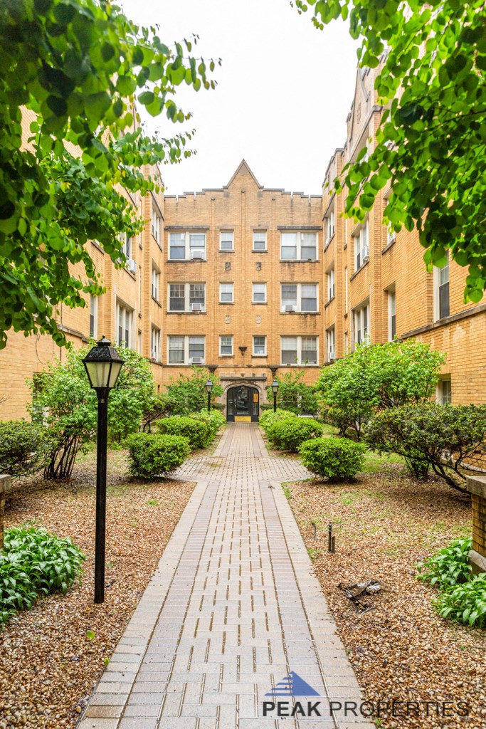 a path leading to a building in a courtyard