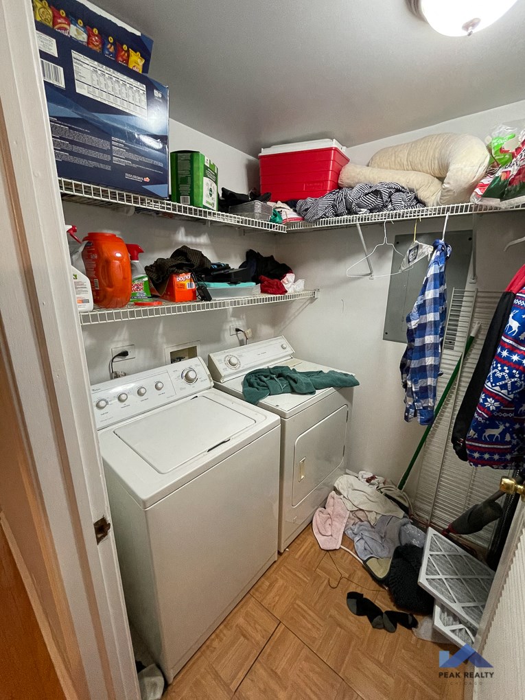 a white washer and dryer in a small laundry room