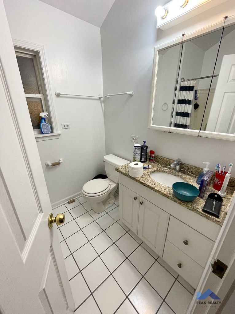a bathroom with a toilet and a sink and a mirror