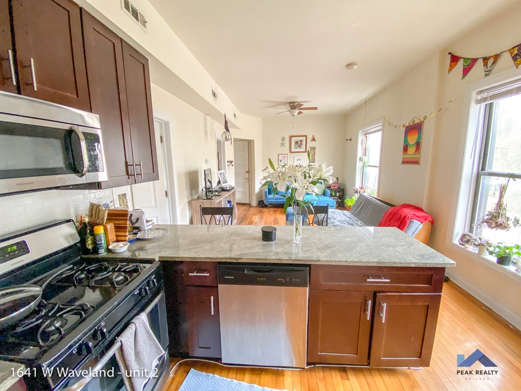 a view of the kitchen and living room from the counter top of a kitchen island