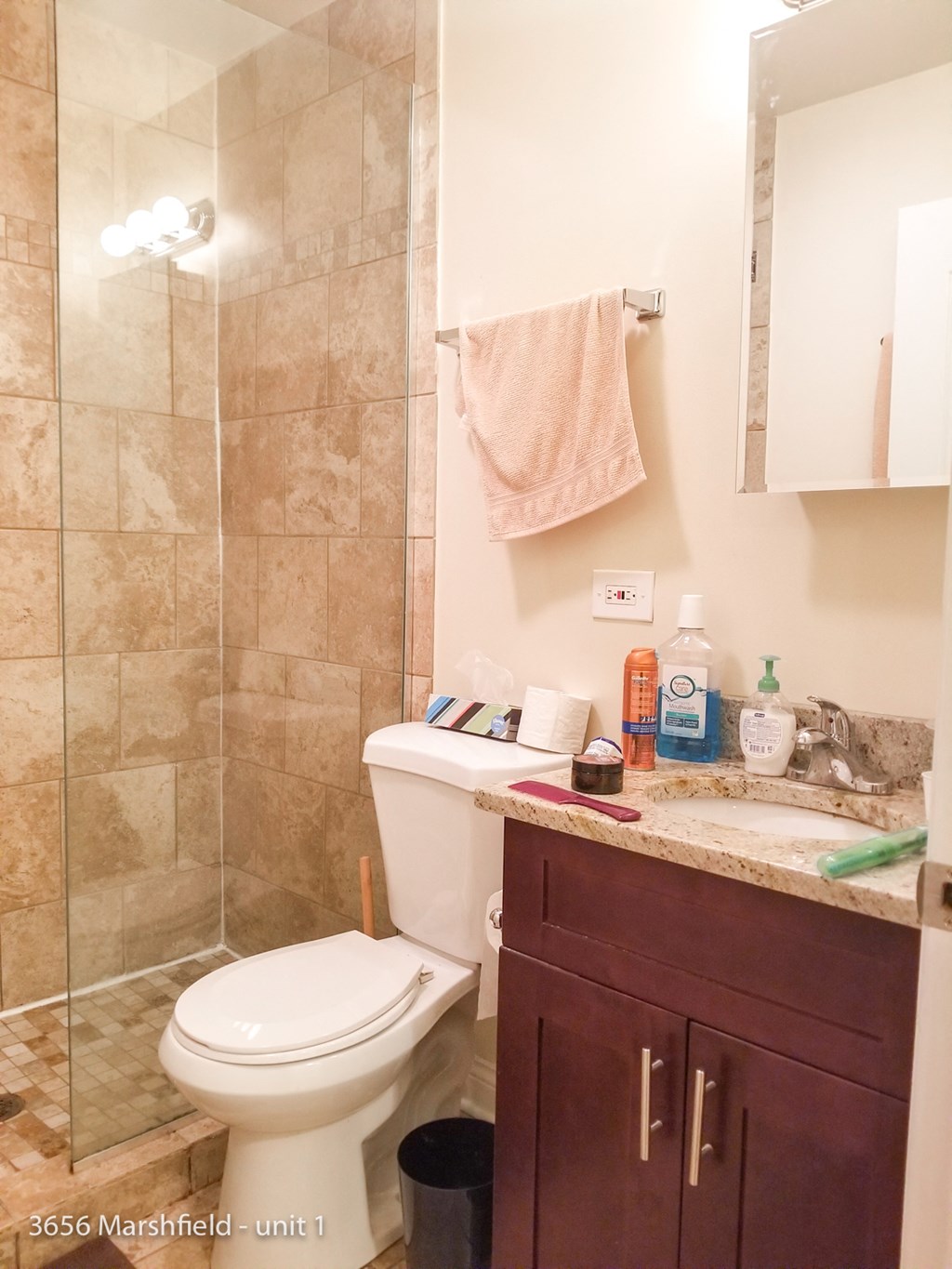 a small bathroom with a shower toilet and sink