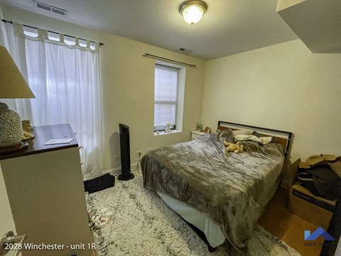 a bedroom with a bed and a dresser and a window