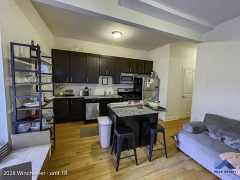 a view of the kitchen and living room of an apartment