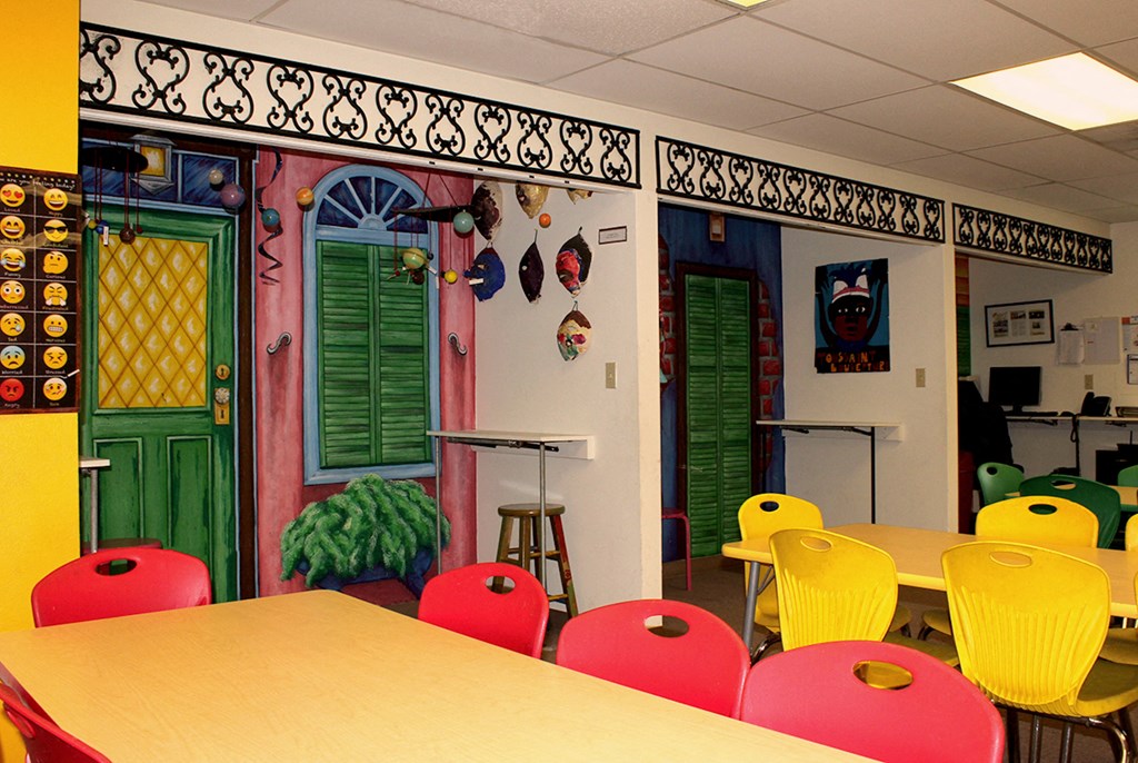 a classroom with colorful chairs and a table
