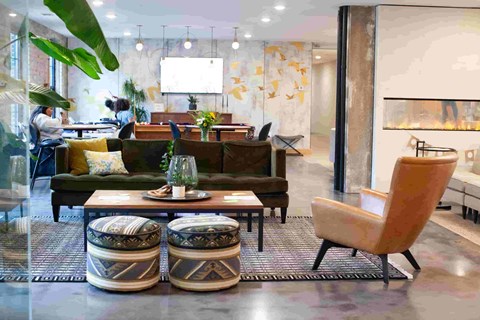 A modern living room with a large couch, a coffee table, and a chair.
