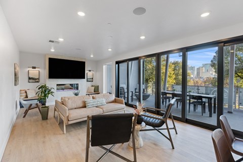 a living room with a couch and chairs and sliding glass doors