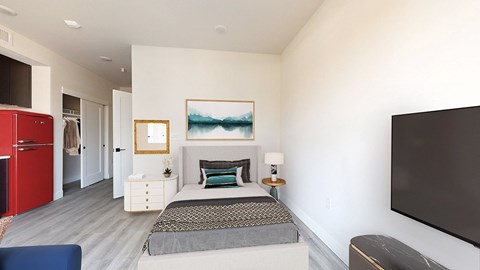 a bedroom with a bed and a tv