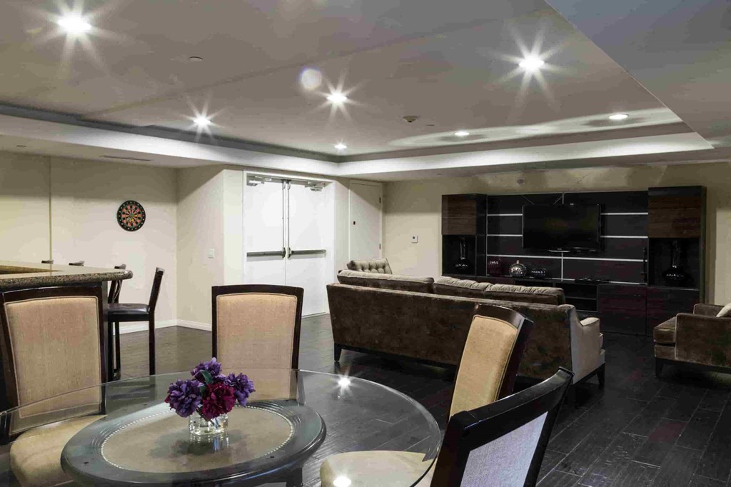 A modern living room with a glass table and chairs.