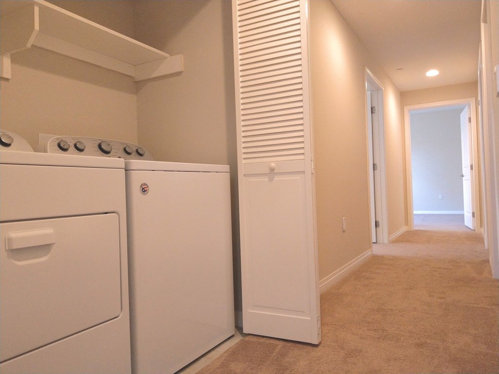 A white washer and dryer in a small laundry room.