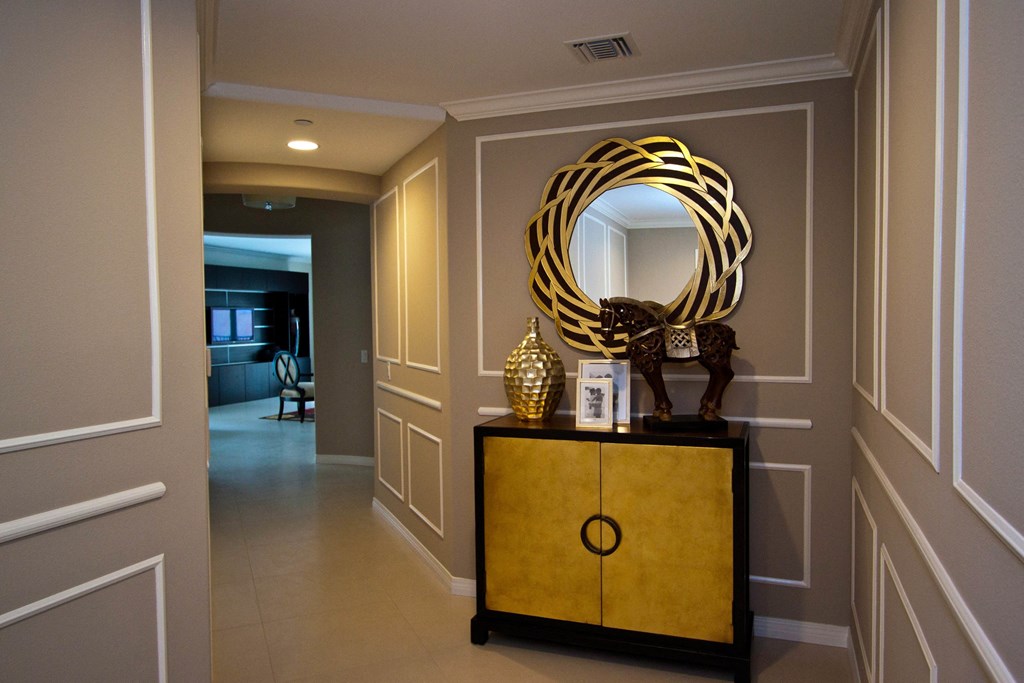 A yellow and black dresser with a mirror on top.