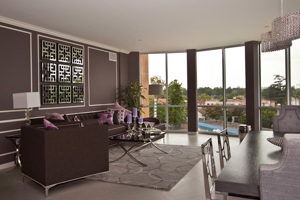 A modern living room with a large window and a view of the outdoors.