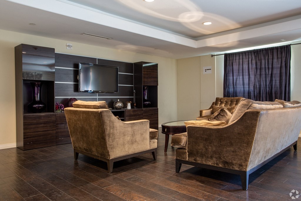 A living room with a brown couch and a television.