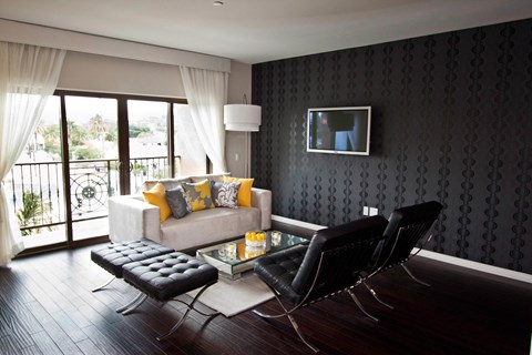 A black and white living room with a couch, chair, and television.