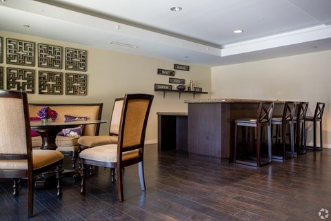 A dining room with a table set for four.