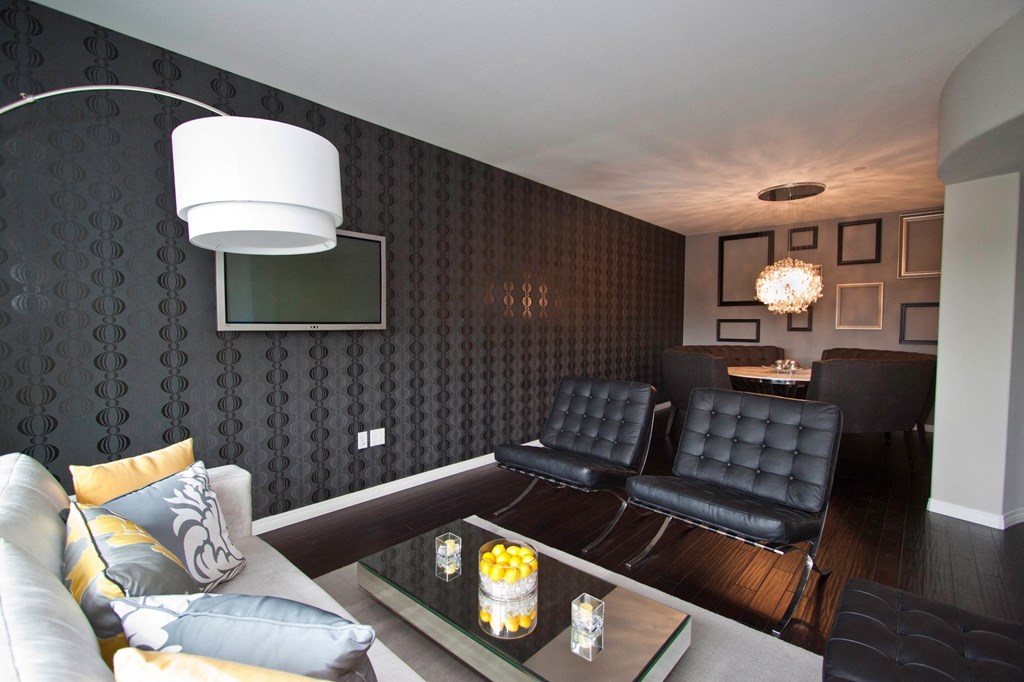 A modern living room with a white couch and a black couch.