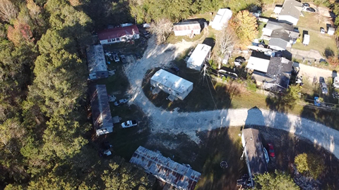 A bird's eye view of a residential area with houses and cars.