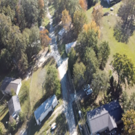 A road cuts through a residential area.