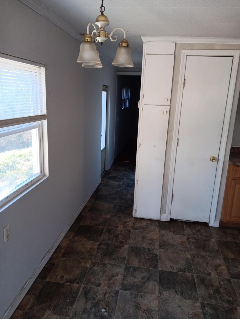 A room with a checkered floor and a white door.