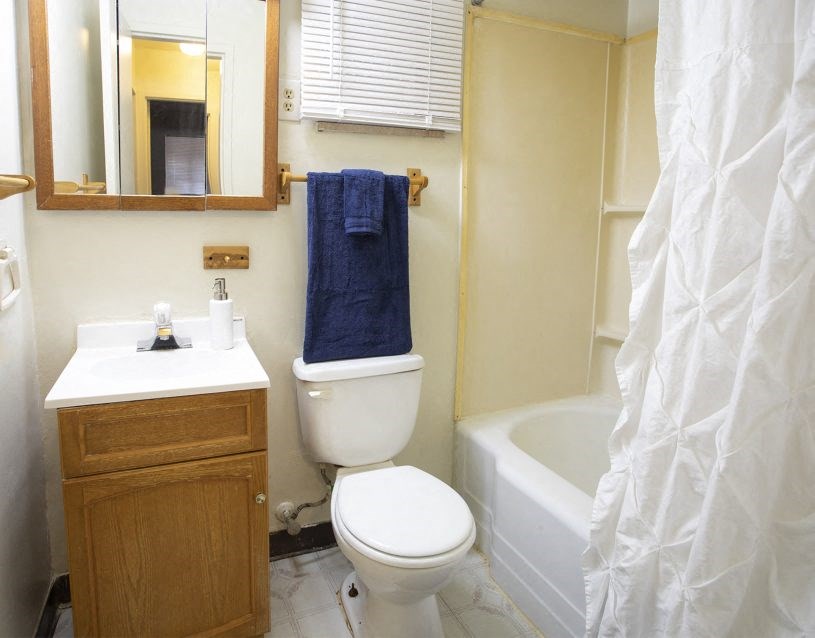 a bathroom with a toilet and a sink and a bath tub