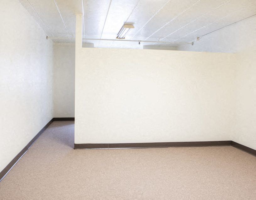 an empty room with a white wall and a ceiling
