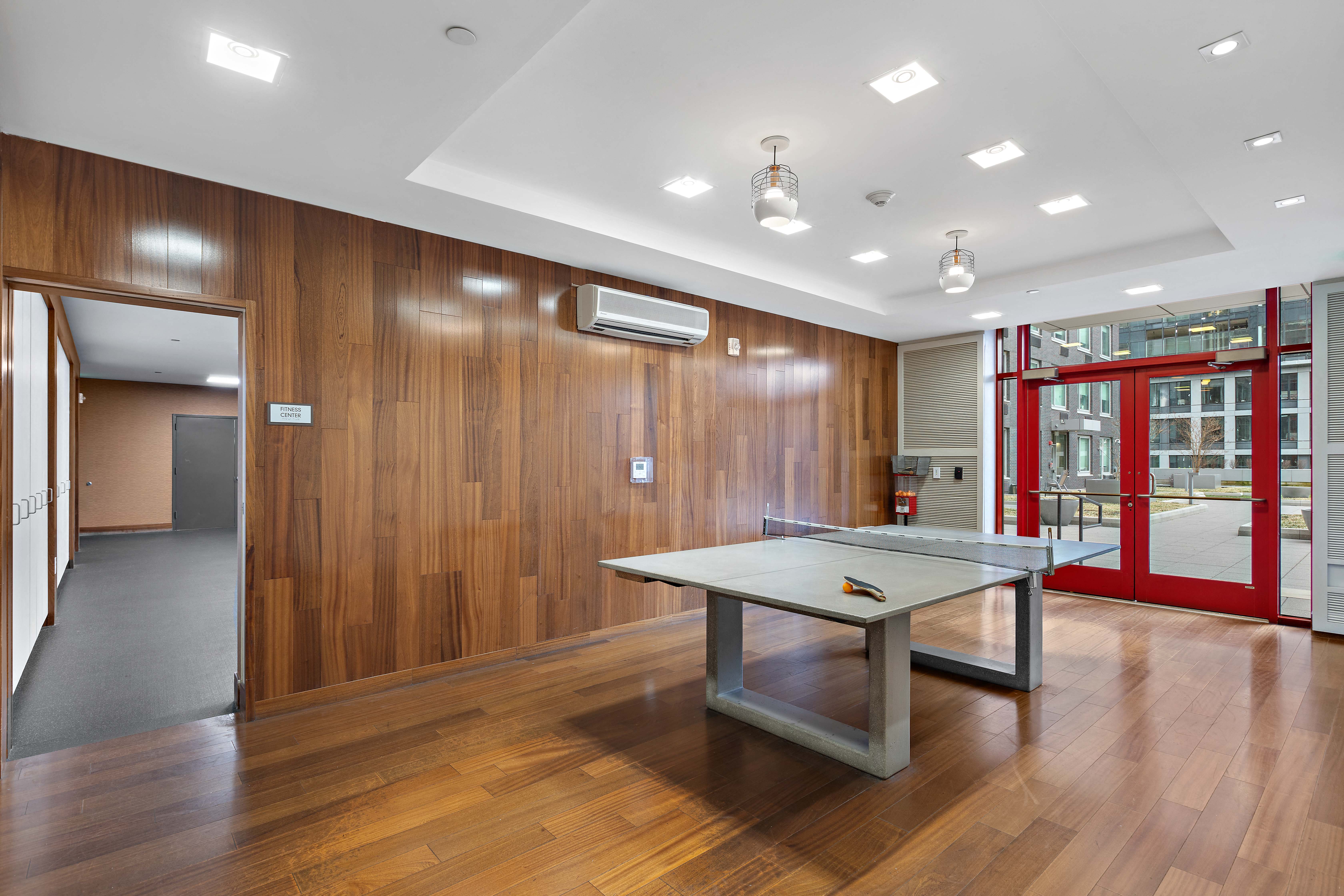 a room with a ping pong table in the middle of it