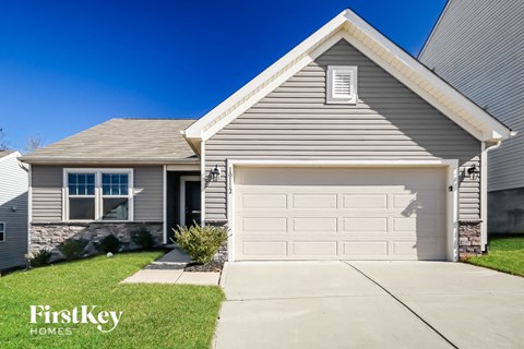 A house with a garage and a clear blue sky.