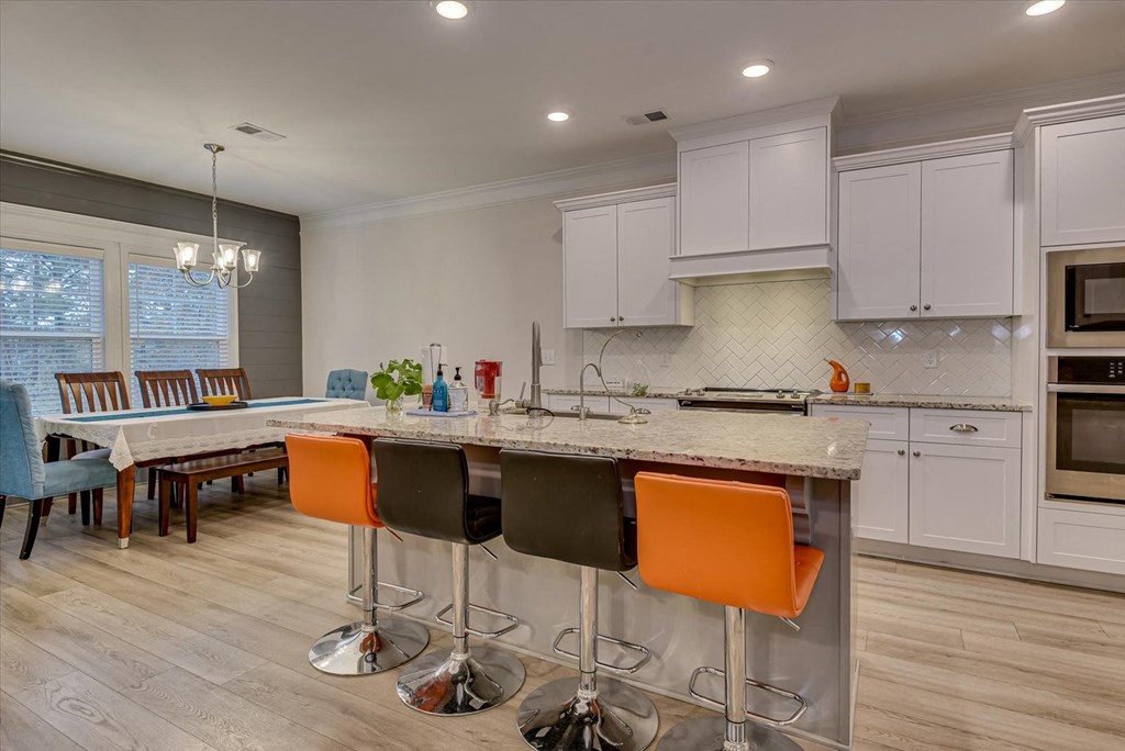 a kitchen with an island and a dining table