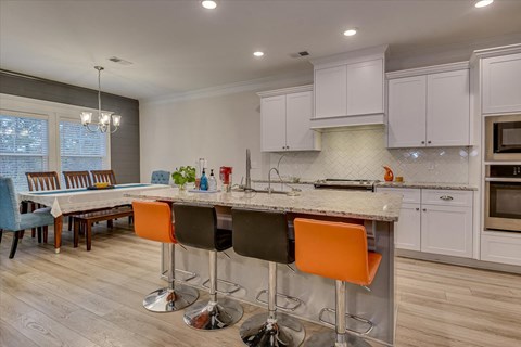 a kitchen with an island and a dining table