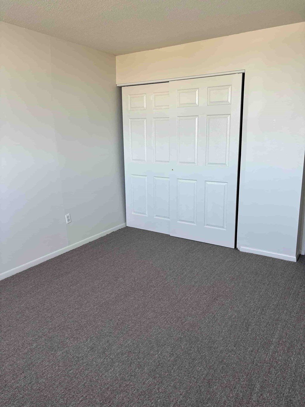 A white double door is closed.